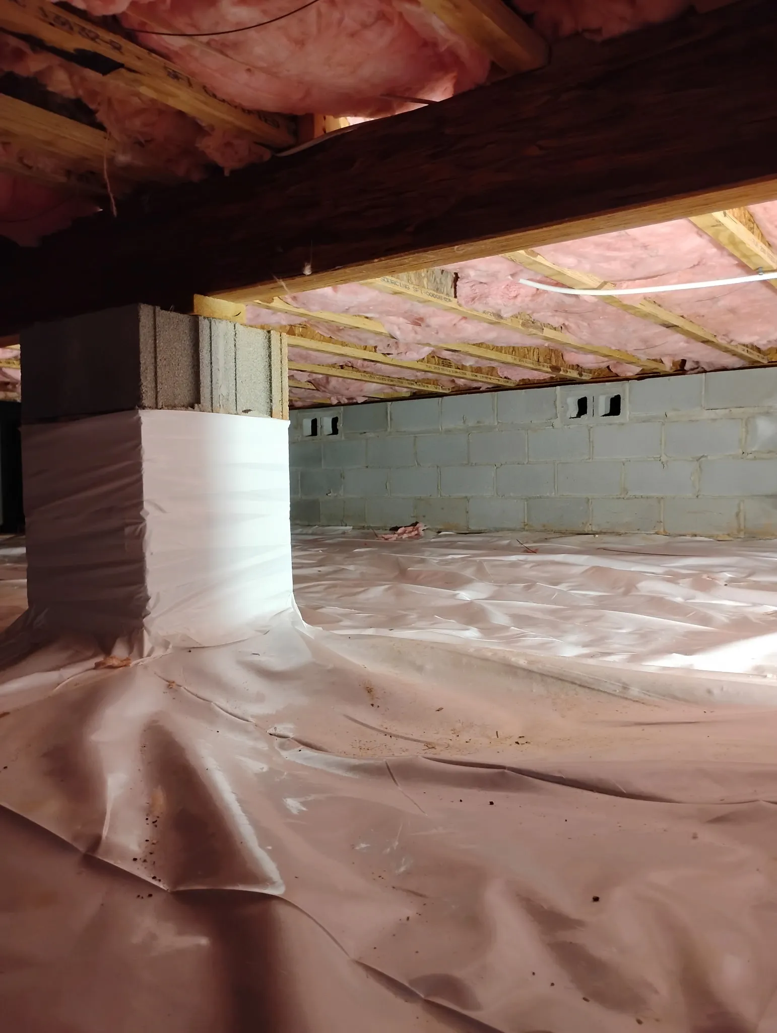 An installed crawlspace vapor barrier