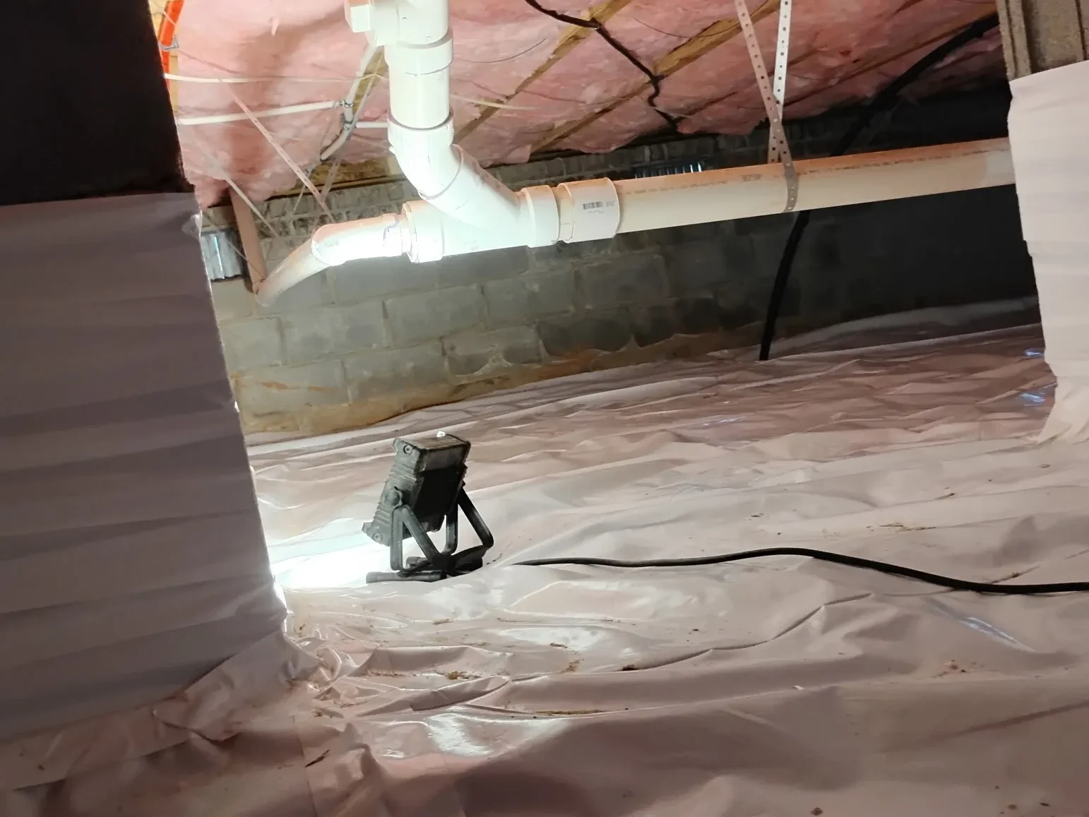 An installed crawlspace vapor barrier